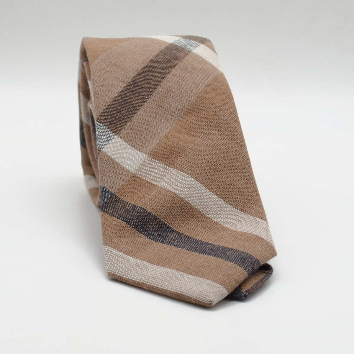 Tan and Cream Plaid Necktie rolled on a light background