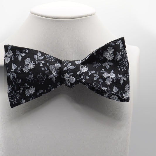 Black and Silver Floral Bow Tie shown on a white display stand