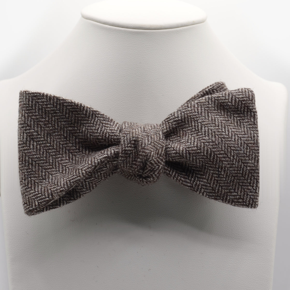 Brown and Gray Herringbone Bow Tie shown on a white display stand