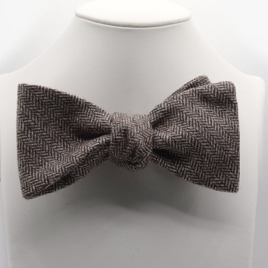 Brown and Gray Herringbone Bow Tie shown on a white display stand