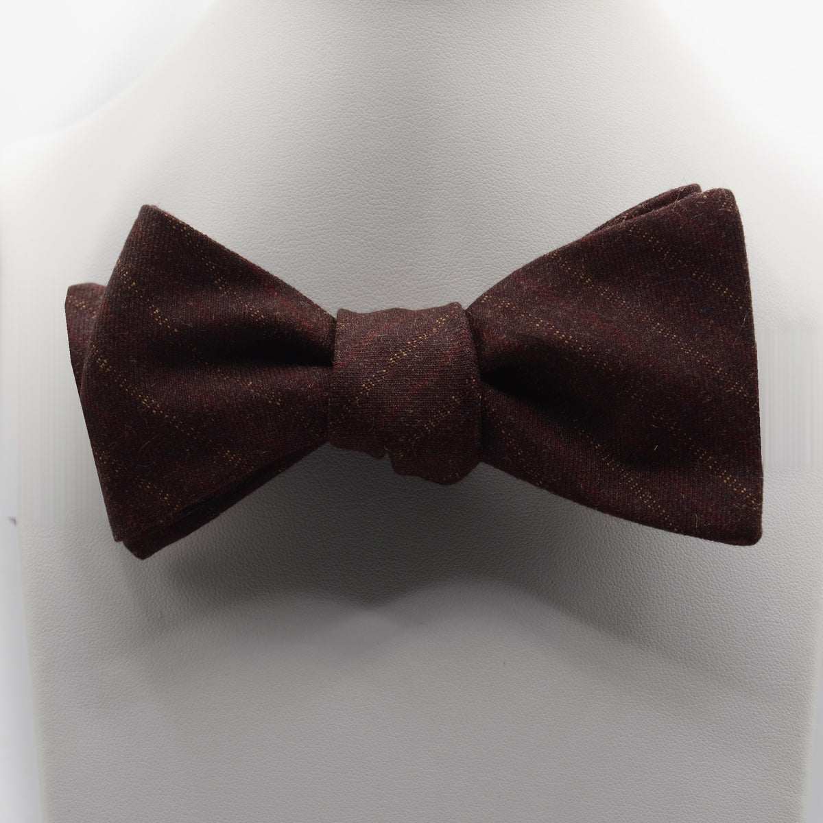 Burgundy Textured Bow Tie shown on a white display stand