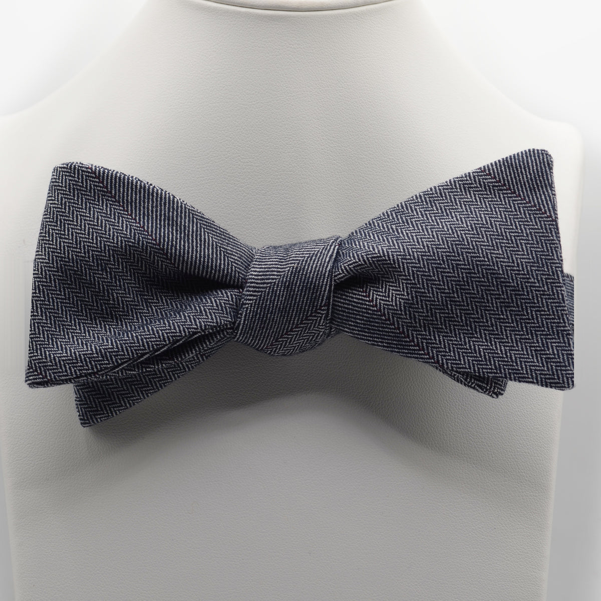 Charcoal Patterned Bow Tie shown on a white display stand