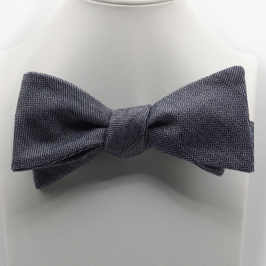 Charcoal Patterned Bow Tie shown on a white display stand