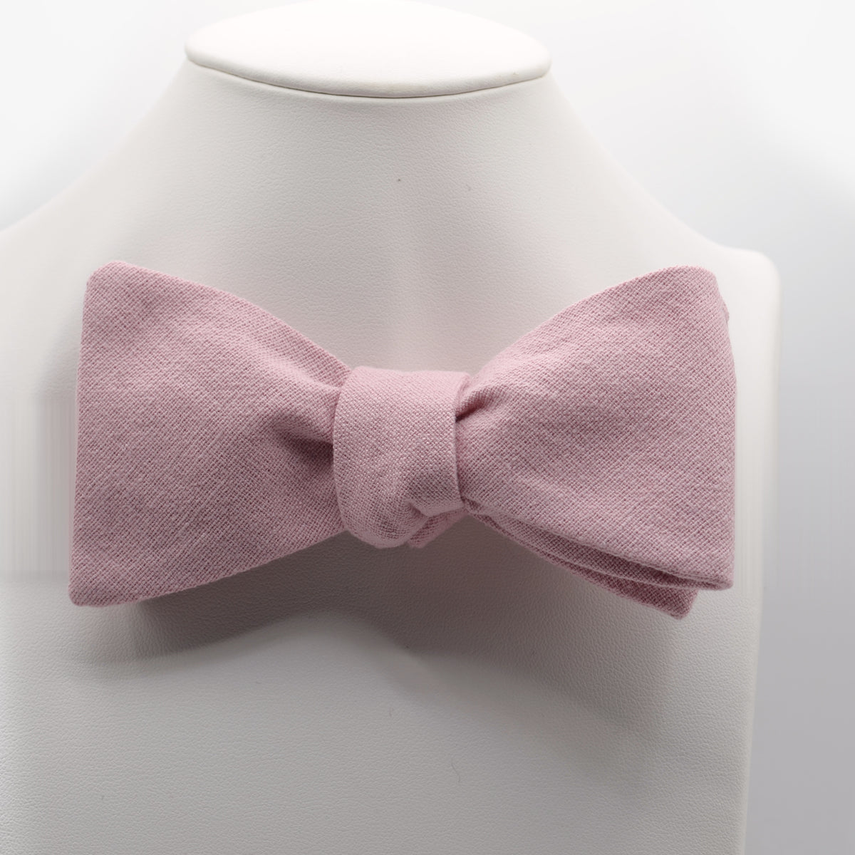 Dusty Pink Bow Tie shown on a white display stand