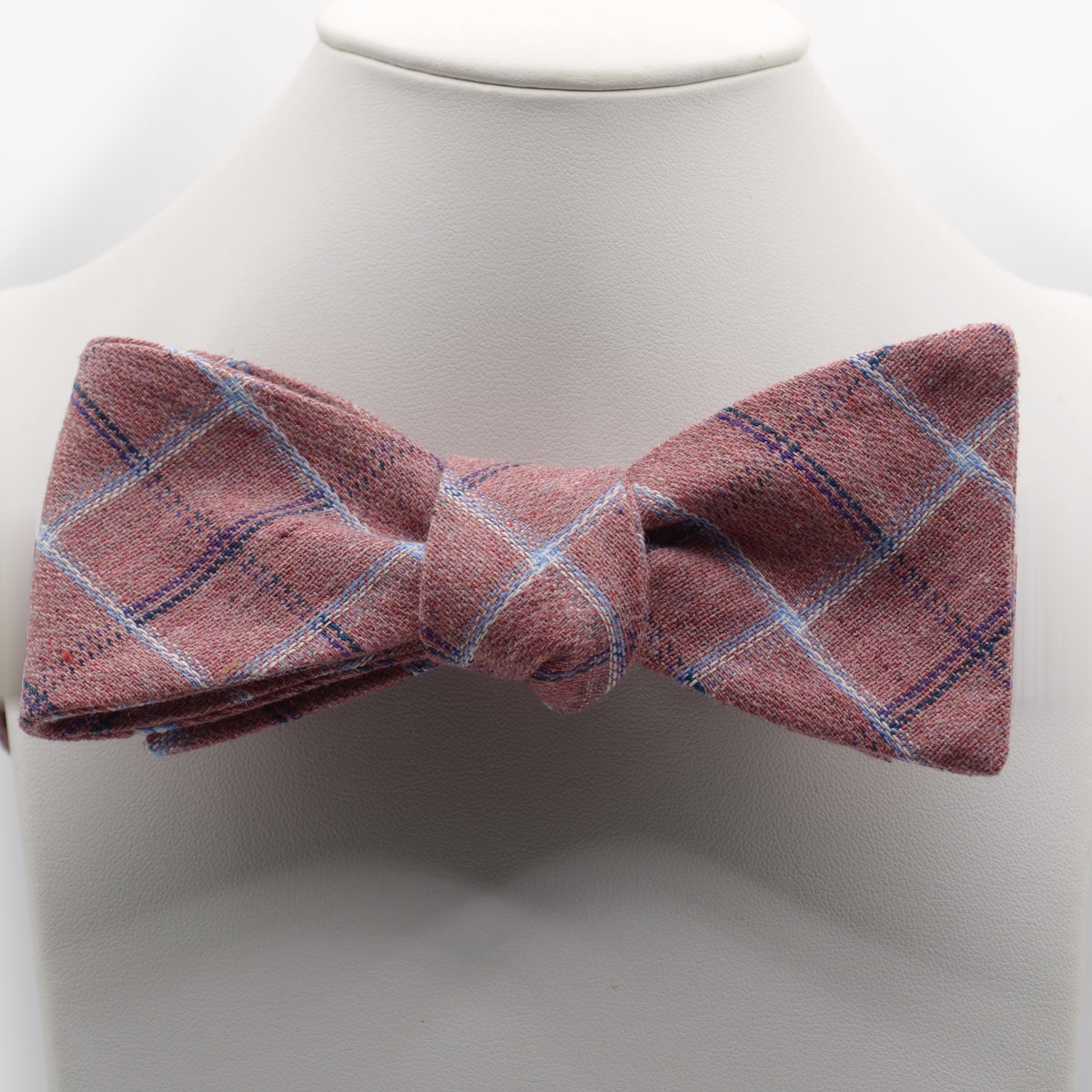 Dusty Rose Plaid Bow Tie shown on a white display stand