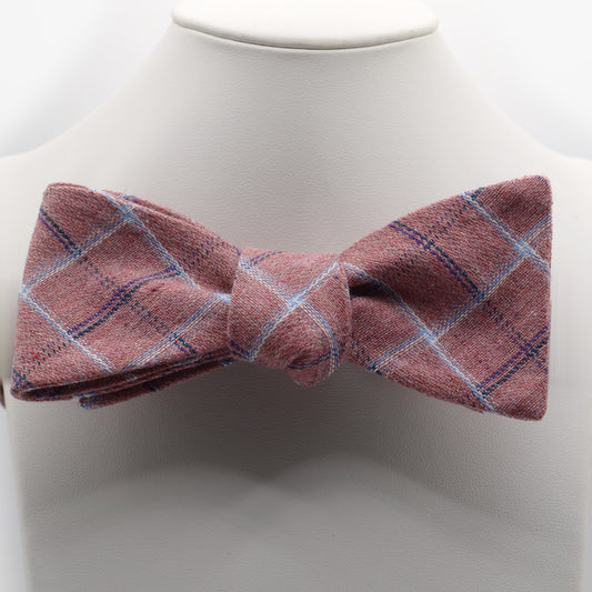 Dusty Rose Plaid Bow Tie shown on a white display stand