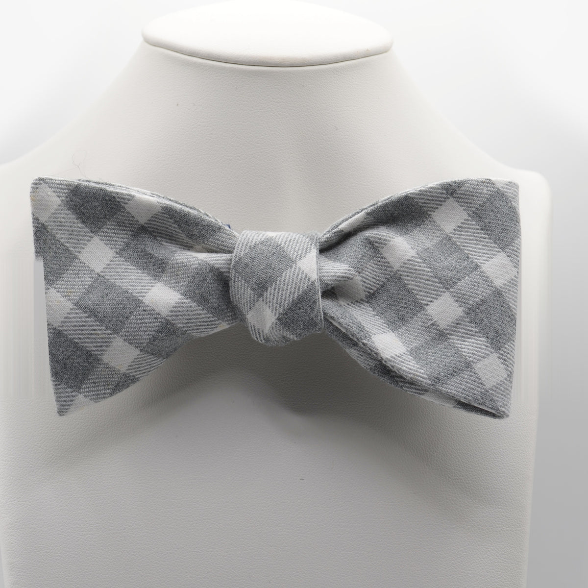Gray Gingham Bow Tie shown on a white display stand