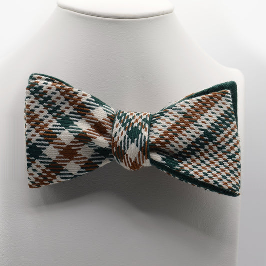 Green Brown and Cream Patterned Bow Tie shown on a white display stand