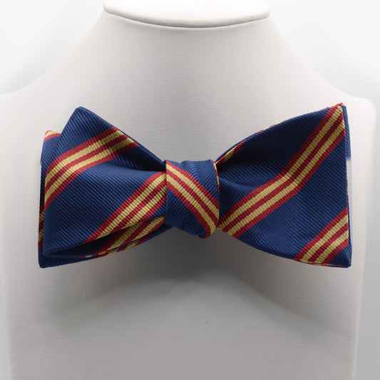 Navy Red and Gold Stripe Bow Tie shown on a white display stand