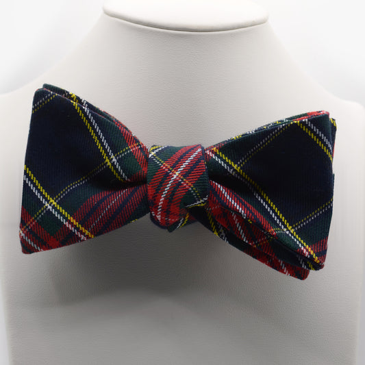 Navy Tartan Bow Tie shown on a white display stand