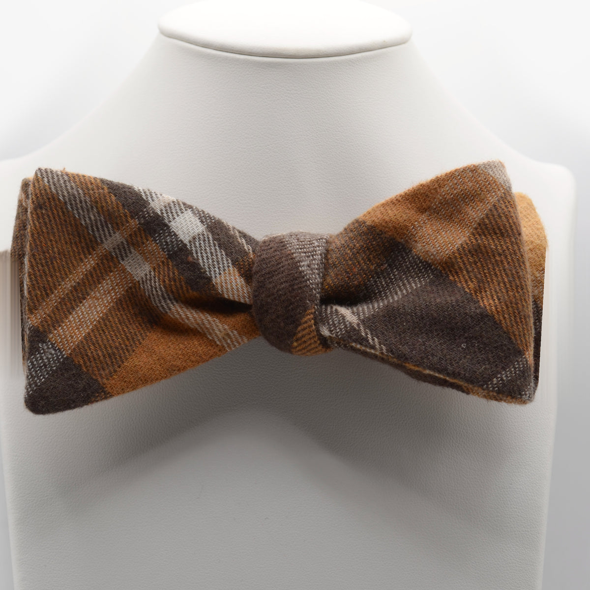 Ochre and Brown Plaid Bow Tie shown on a white display stand