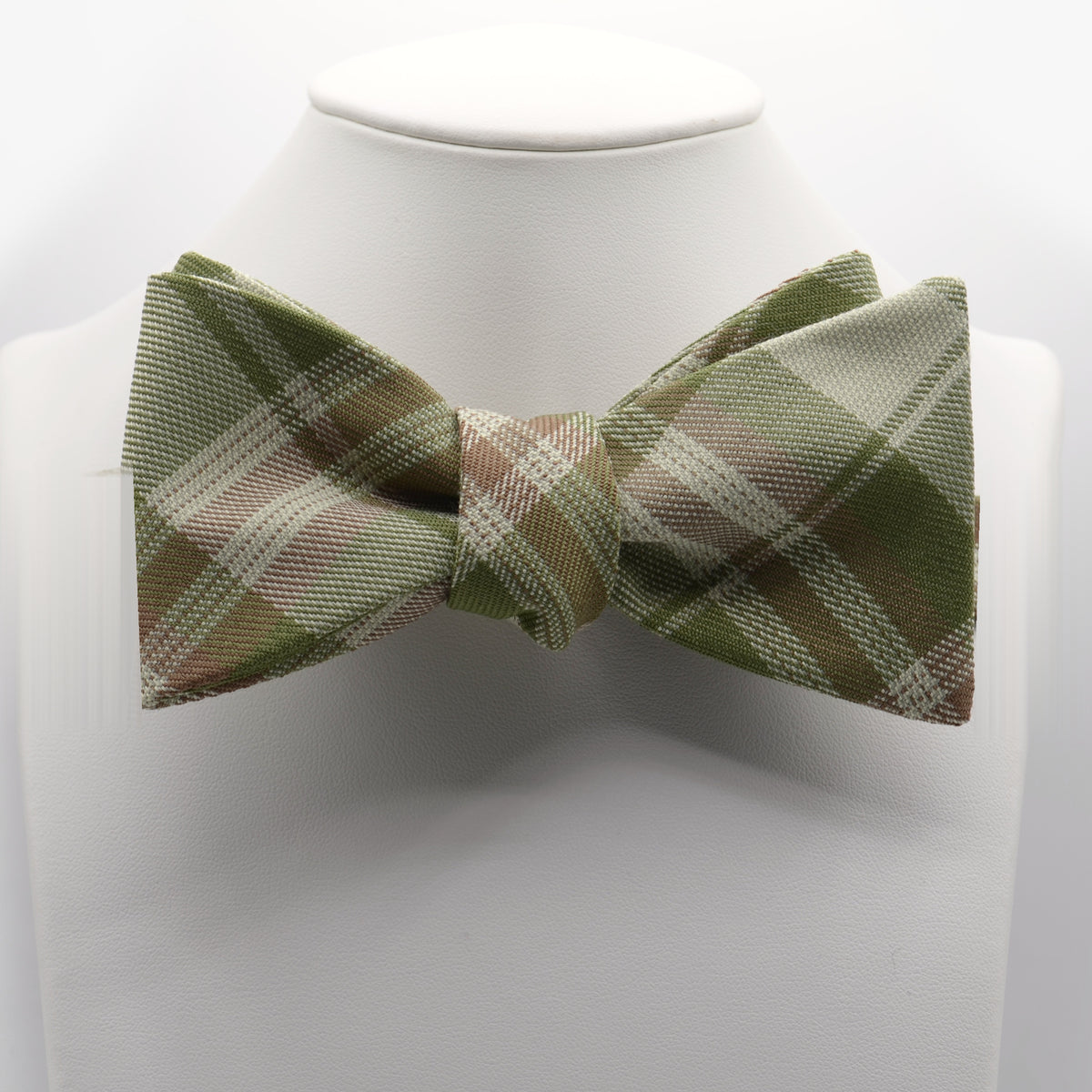 Olive and Tan Plaid Bow Tie shown on a white display stand