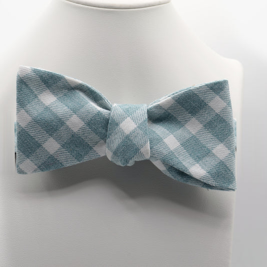 Sage Blue Gingham Bow Tie shown on a white display stand