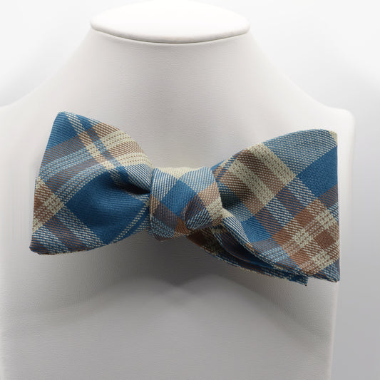 Teal and Tan Plaid Bow Tie shown on a white display stand